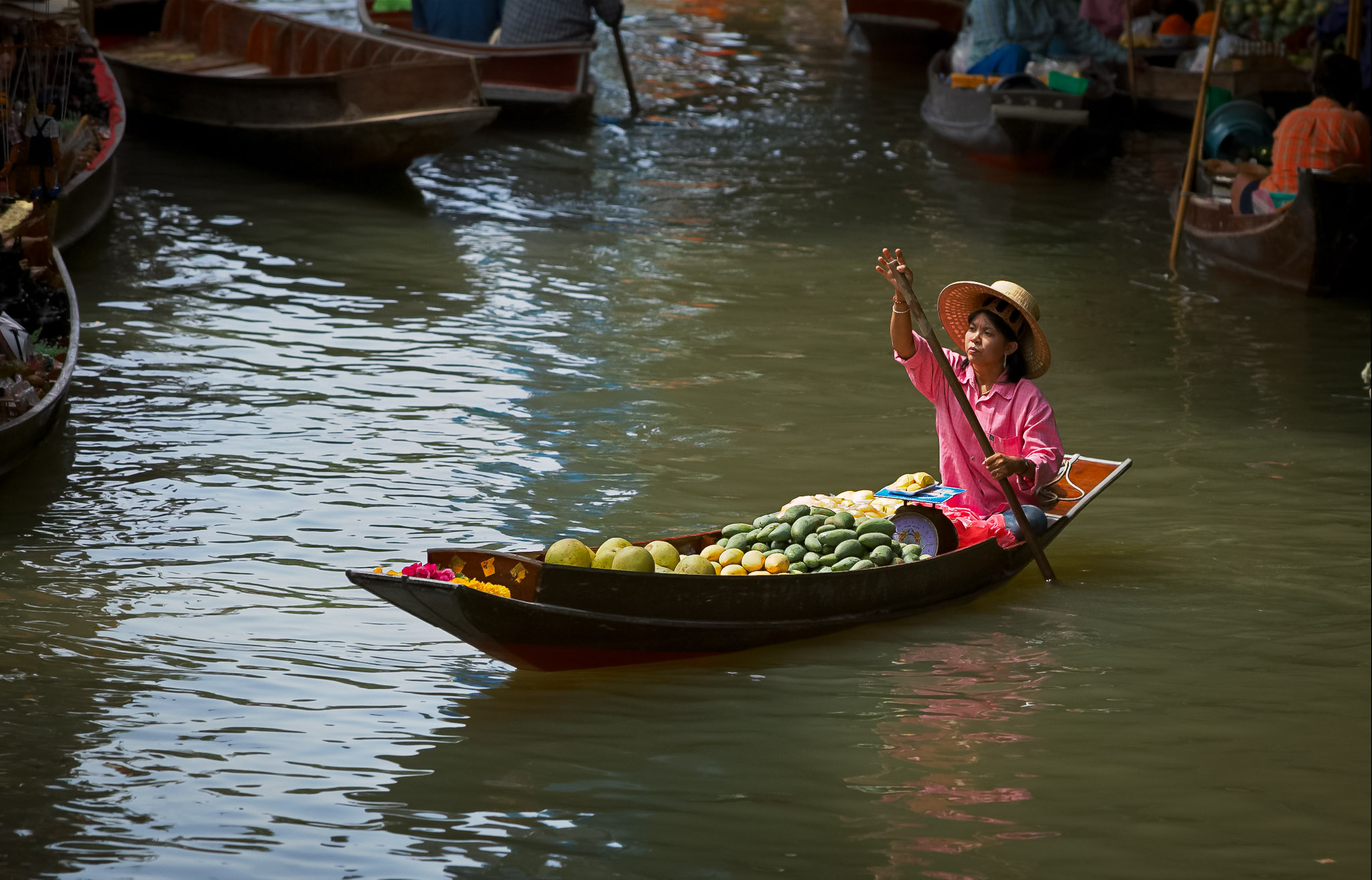 Produce vendor at Damnoen Saduak Floating Market, Thailand