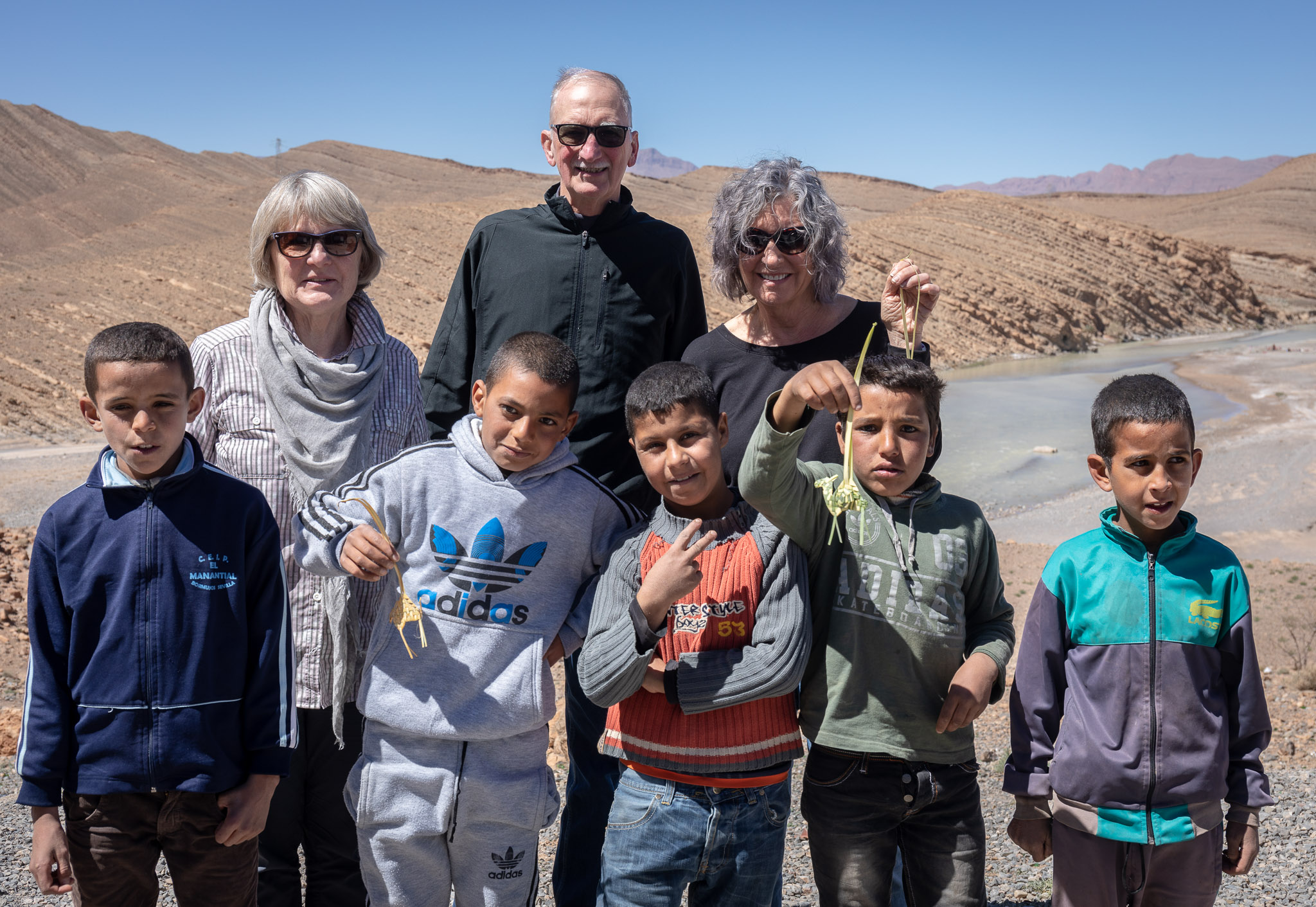 Kids selling palm leaf camels on roadside