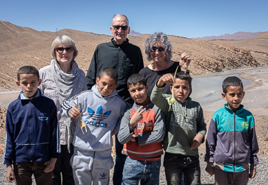 Kids selling palm leaf camels on roadside