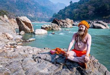 Sadhu on the Ganges emerging from the Himalaya