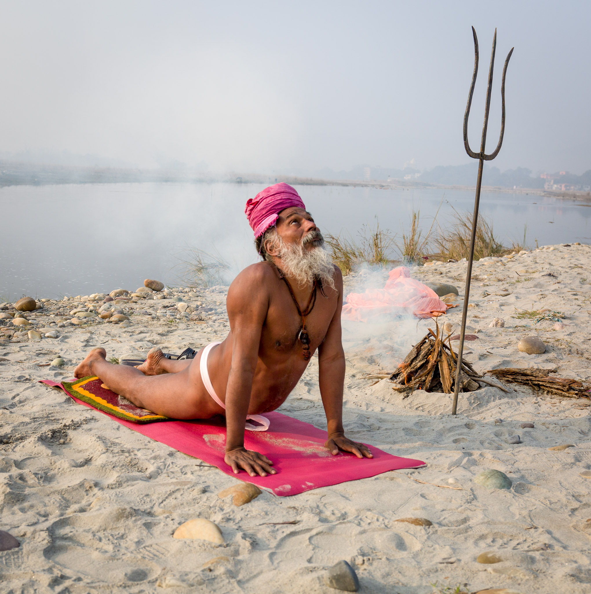 Yogi practicing yoga along the Ganges