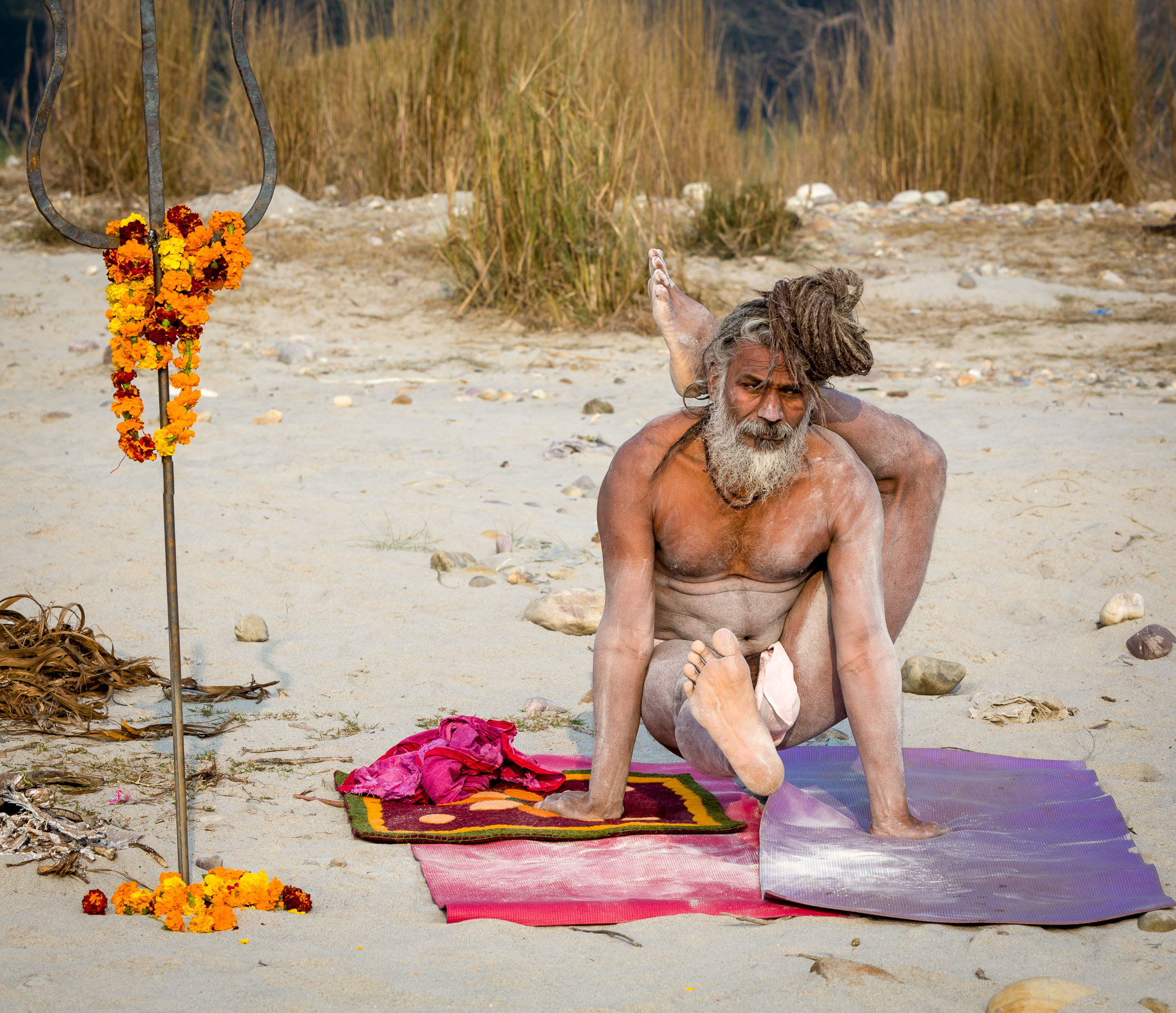 Yogi practicing yoga along the Ganges