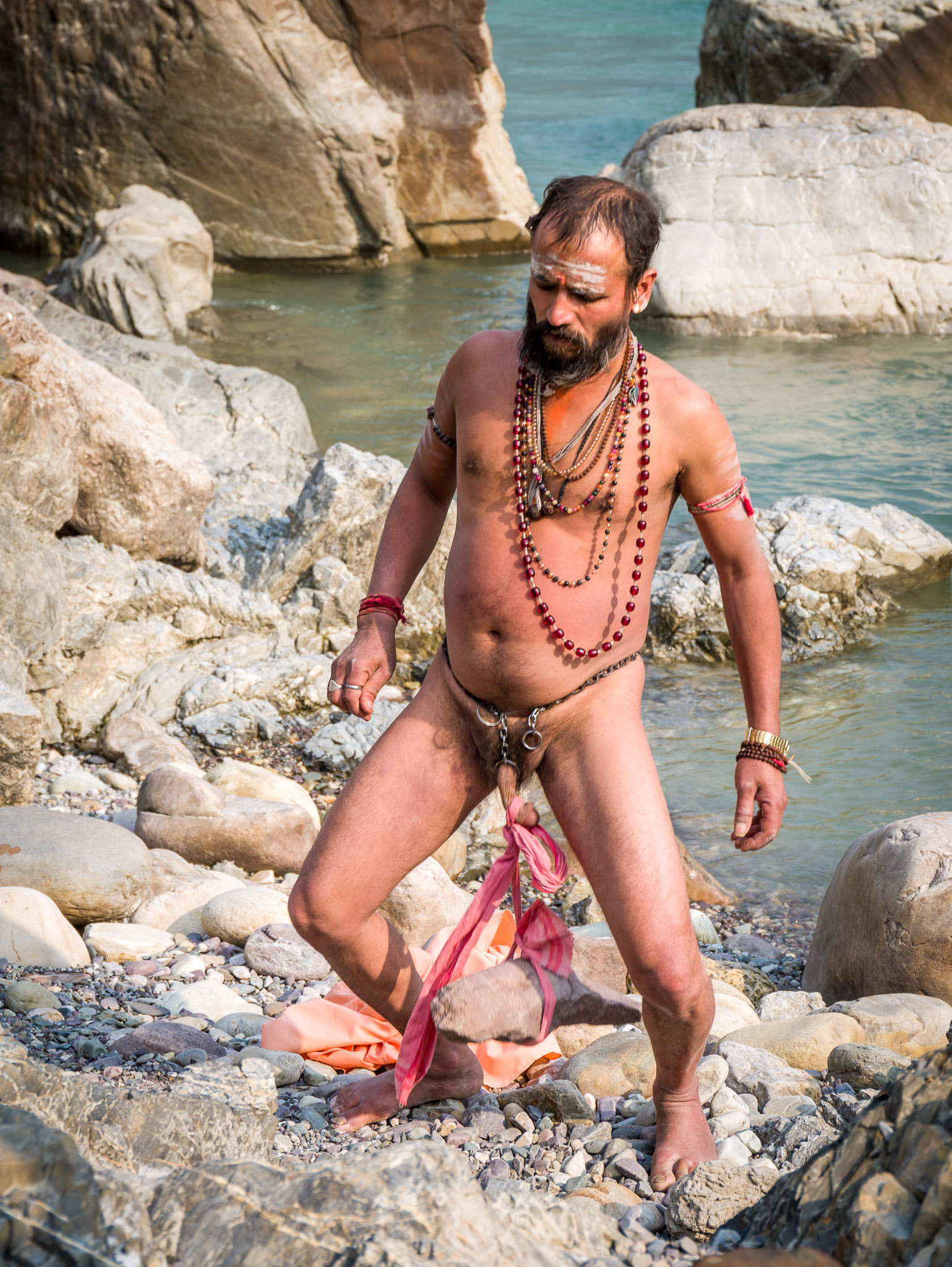 Sadhu lifting a rock the hard way