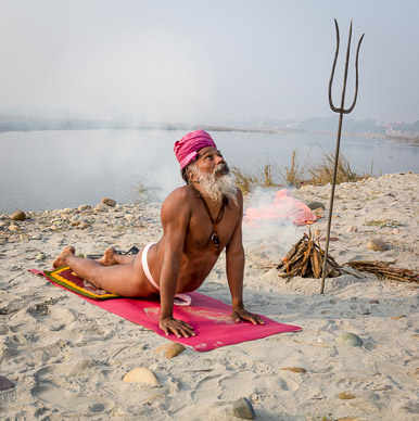Yogi practicing yoga along the Ganges