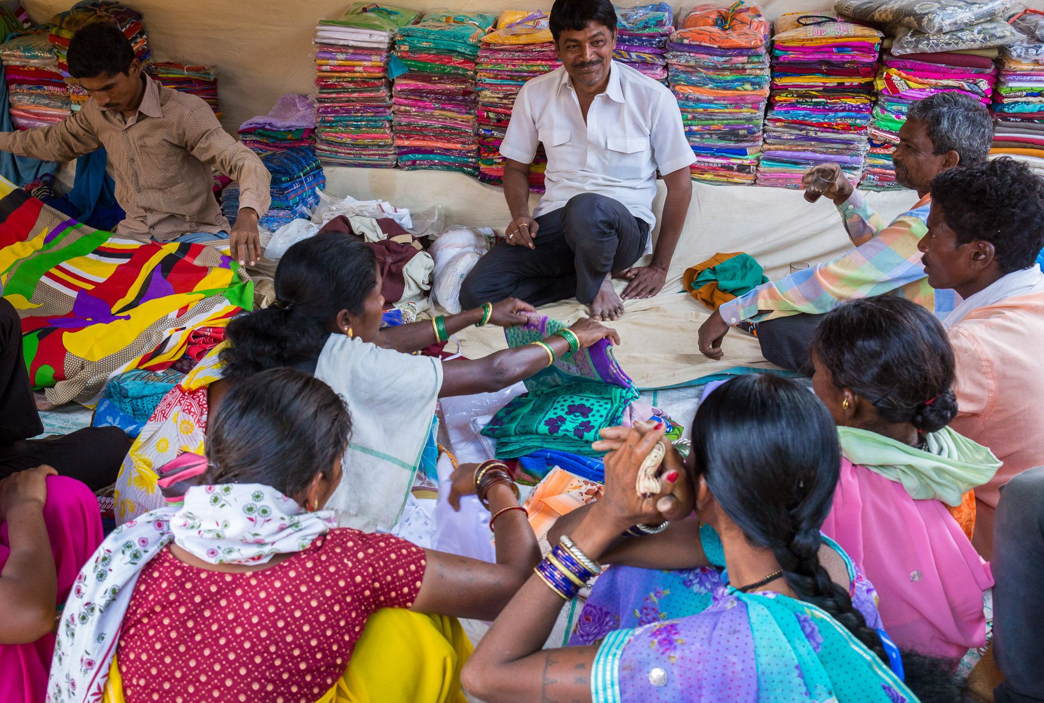 Extended family helping purchase sari material at Dudhawa market