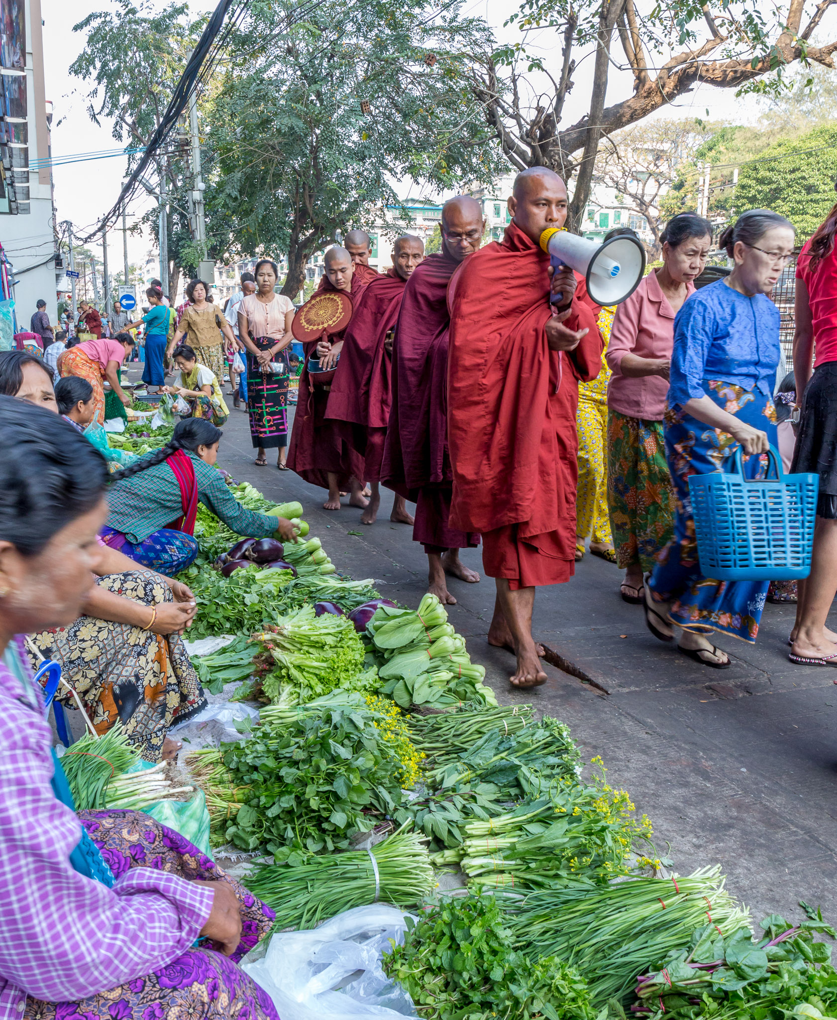 Morning collection of alms by Buddhist monks in Chinese market