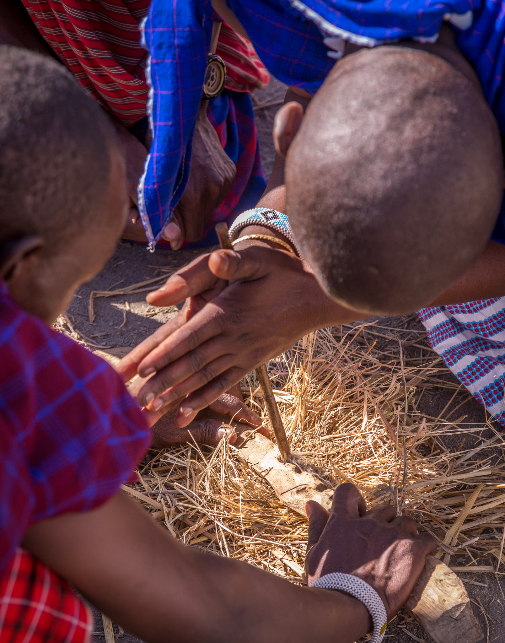 Maasai men starting a fire by friction