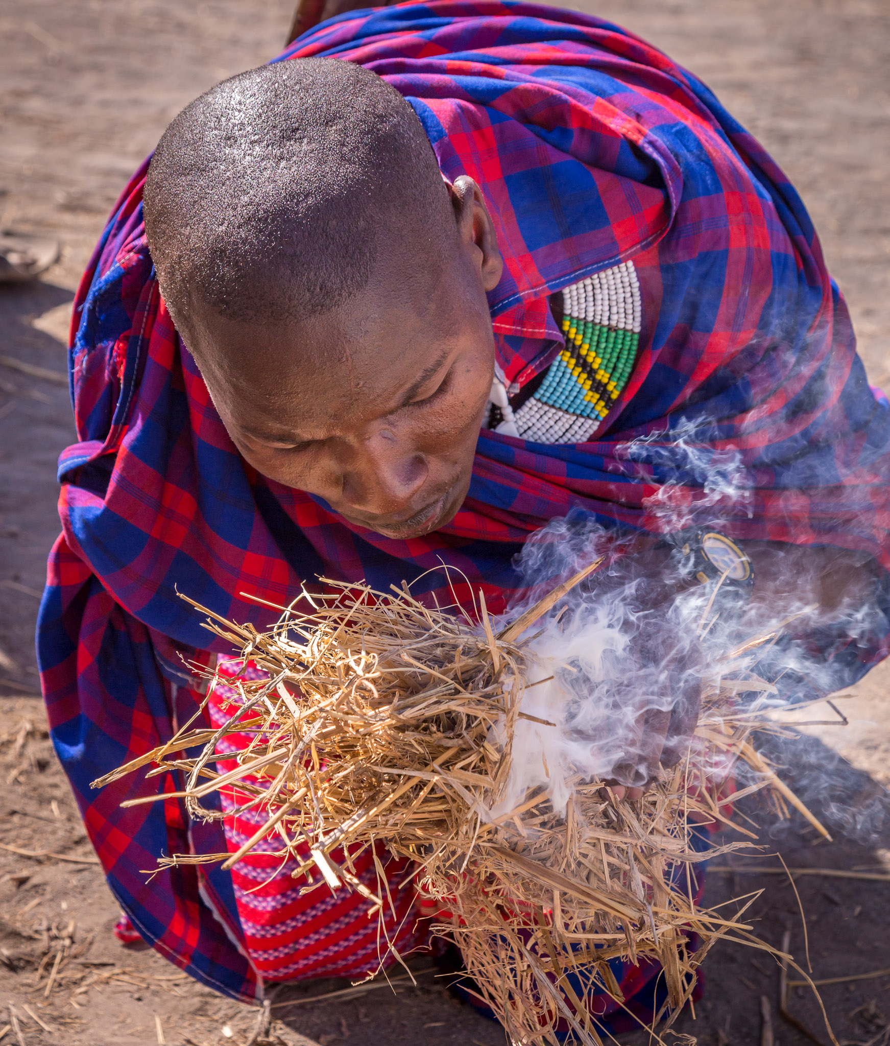 Maasai men starting a fire by friction