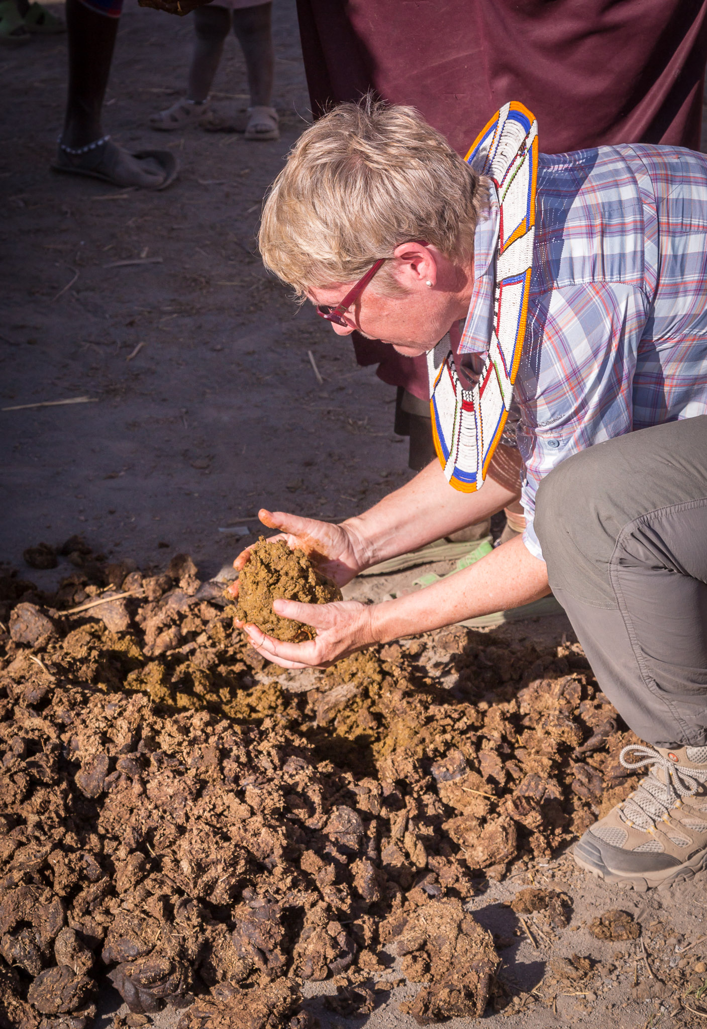 Learning how to surface Maasai hut with dung & mud