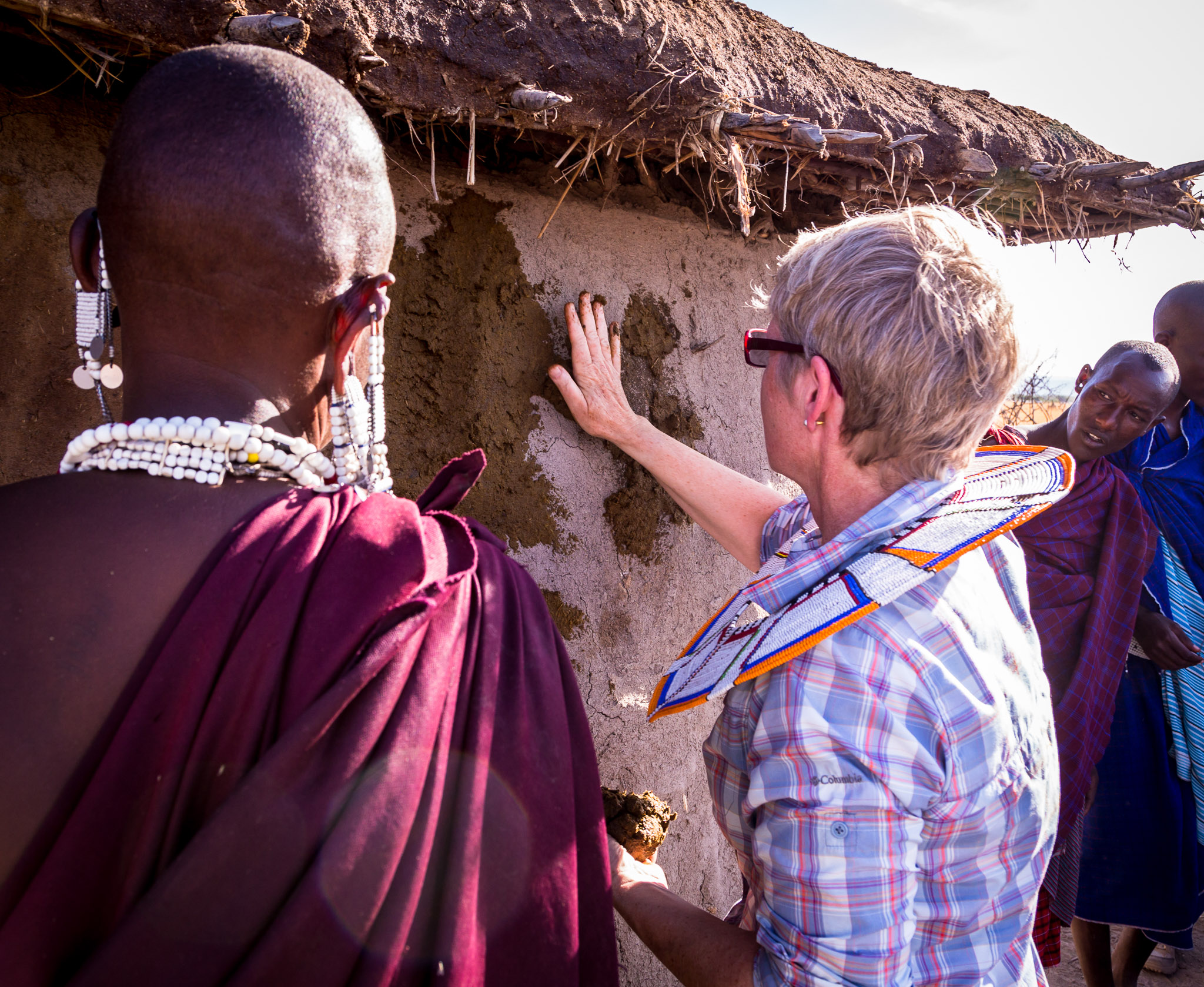 Learning how to surface Maasai hut with dung & mud