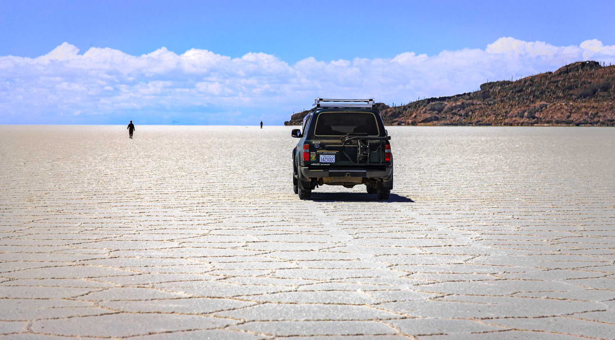 Martha walking to Isla Incahuasi & Paulino following, Salar de Uyuni