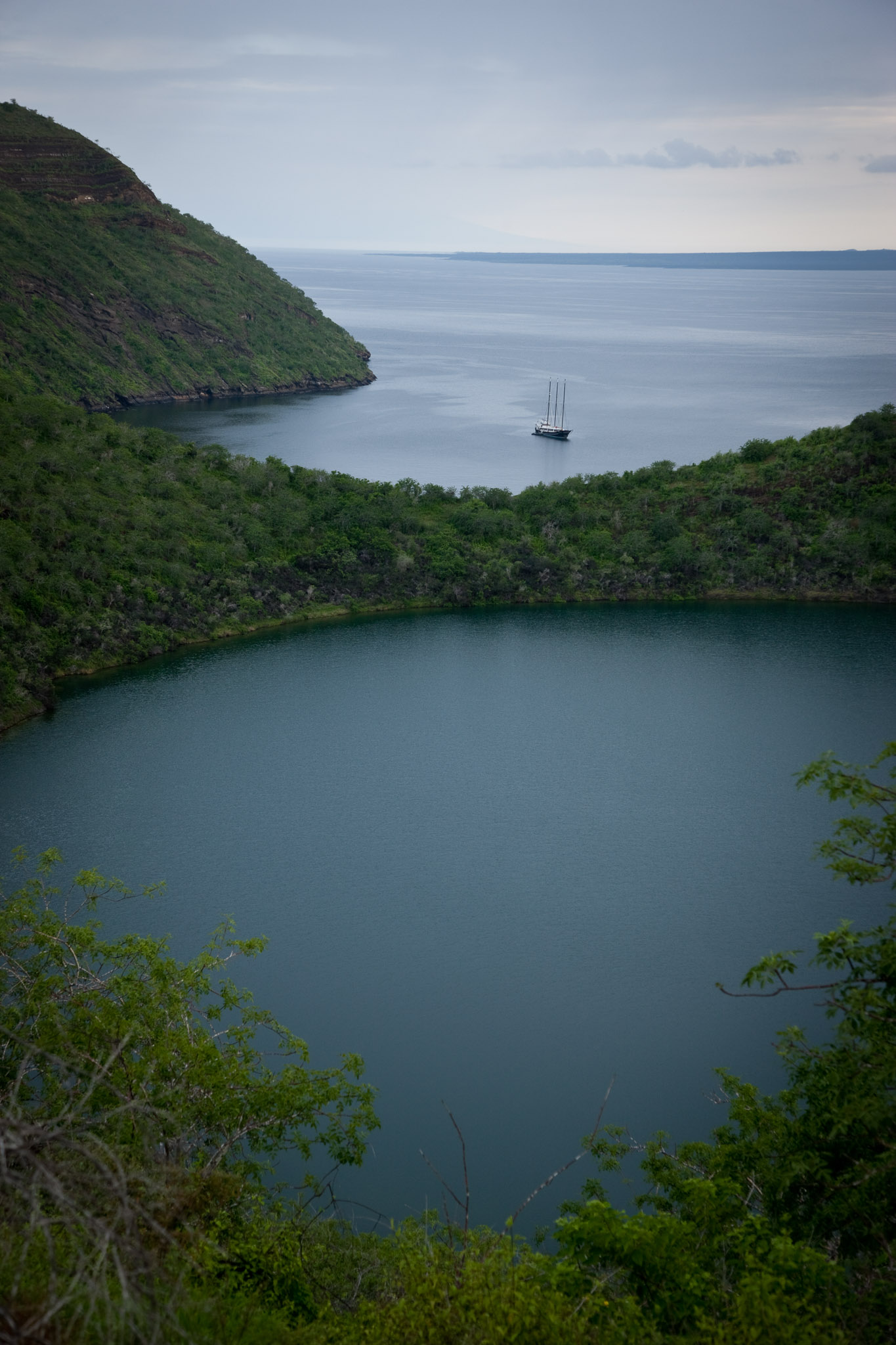 The Alta anchored in Tagus Cove, Darwin lake in the foreground