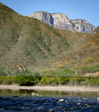 Crossing Urique River on footbridge