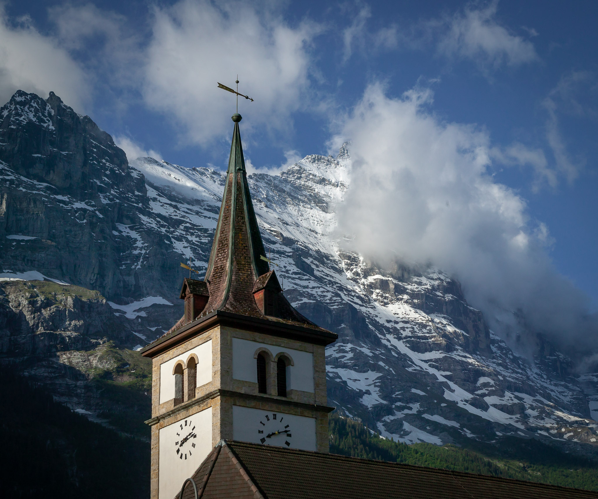 Eiger in clouds behind Grindelwald church