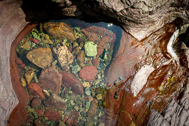 Colorful pool at top of Ptarmigan Falls, Glacier National Park