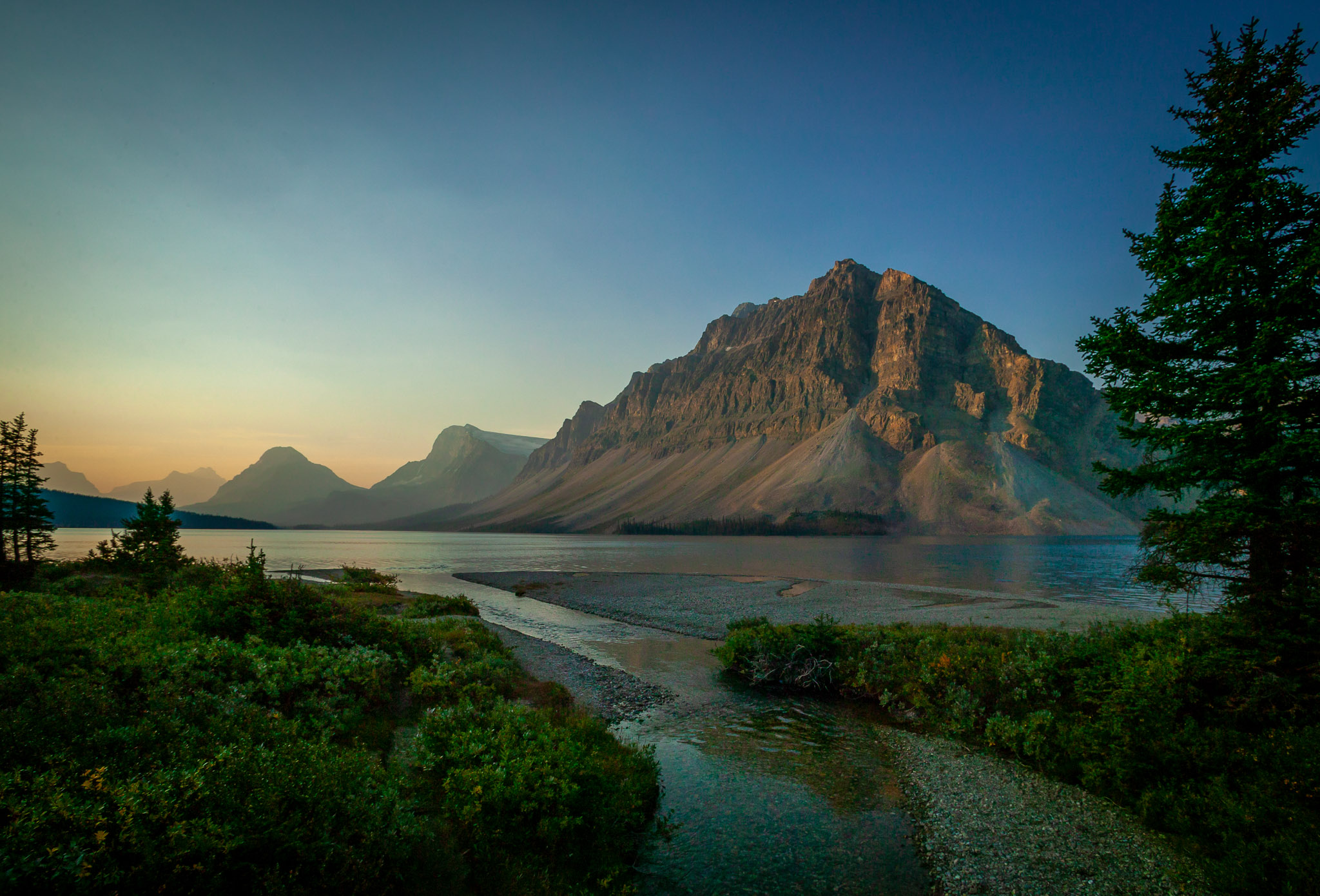 Early light on Crowfoot Mountain over Bow Lake