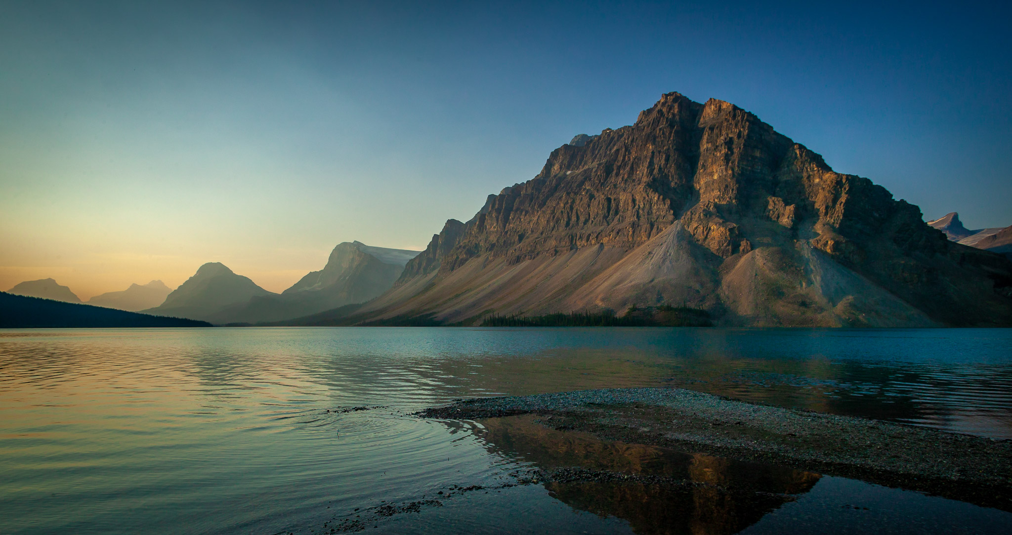Early light on Crowfoot Mountain over Bow Lake