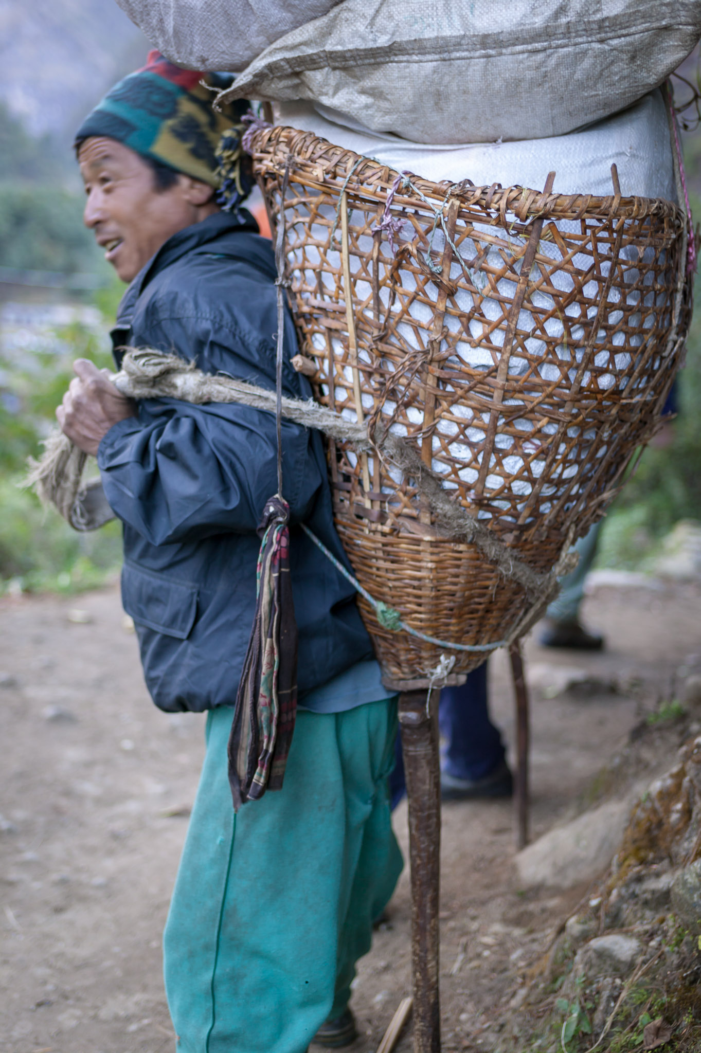Porters carry walking stick, also used to rest the load