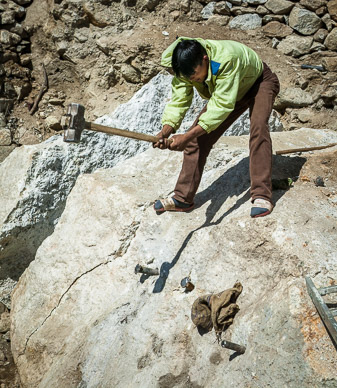 Splitting a boulder for enlargement of Thamo Monastery