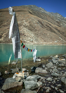 Prayer flags on lakeshore with Gokyo Ri behind