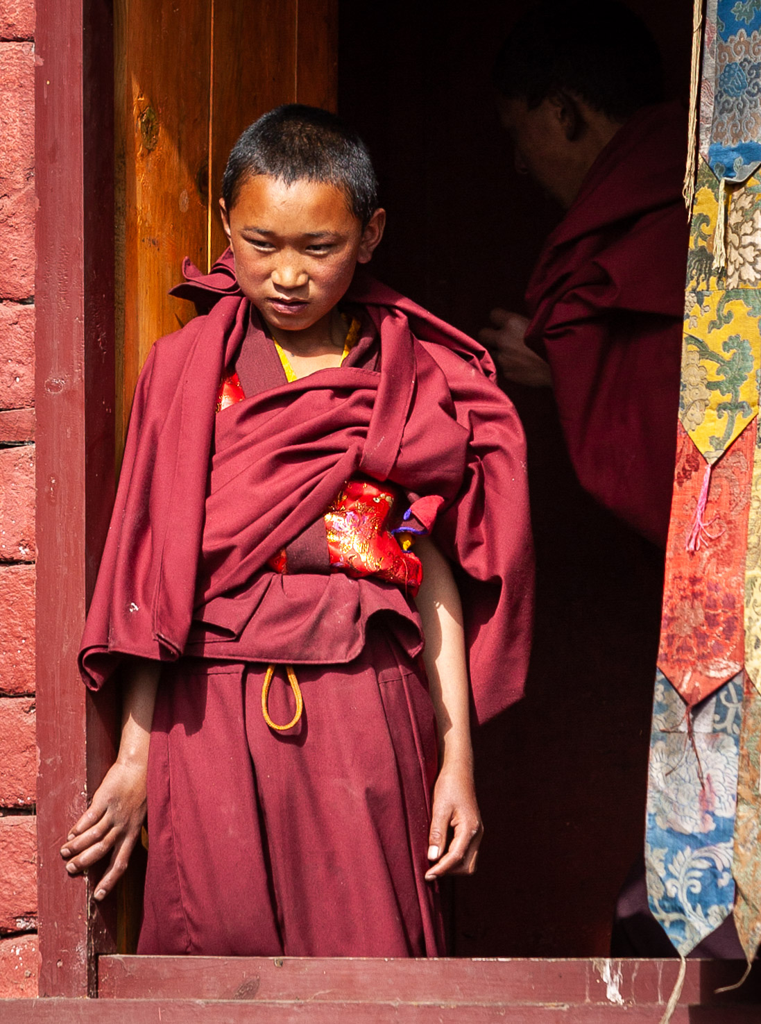 Young monk watching Dance of the Masks