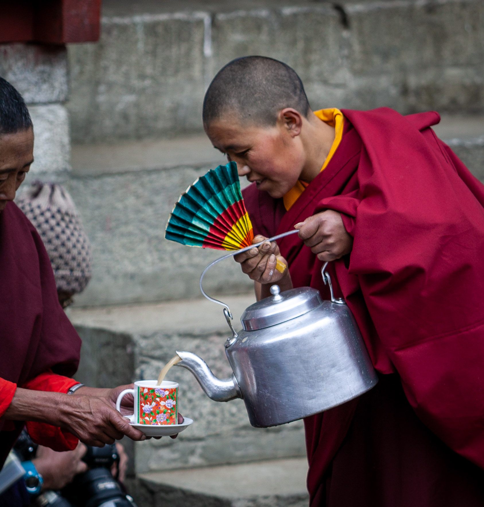 Buddhist nun giving refreshments